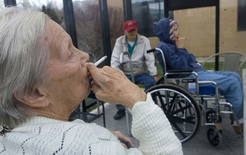 Al Hartmann  |  The Salt Lake Tribune 
Mary Hatfield, who served in the Air Force, enjoys a smoke outside with friends at the Utah State Veterans Nursing Home in Salt Lake City.