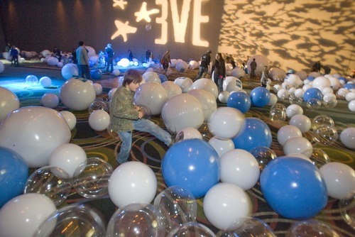 Paul Fraughton  |  The Salt Lake Tribune   Children and adults enjoy playing with a ballroom full of various sized beach balls at the EVE CELEBRATION inside the Salt Palace on  Thursday,December 30, 2010