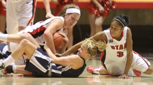 Rick Egan   |  The Salt Lake Tribune

Lady Ute's Michelle Plouffe, and Iwalani Rodrigues battle for  the ball along with Devyn Christensen, Utah State, in Baskteball action Utah vs. Utah State at the Huntsman Center,  Saturday, January 1, 2011