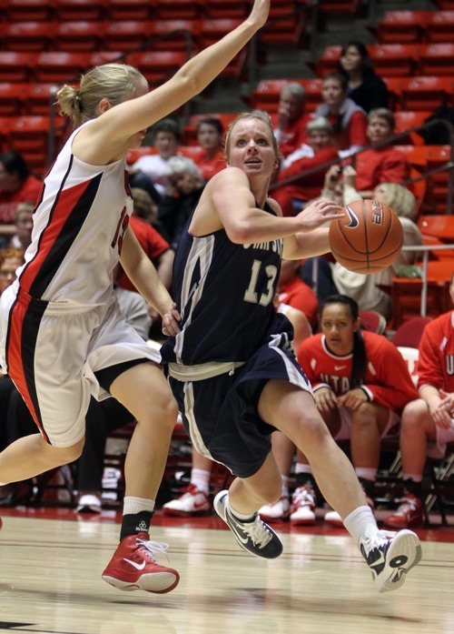 Rick Egan   |  The Salt Lake Tribune

Alice Coddington (13) drives with the ball for Utah State, Diana Rolniak (32) defends for the Lady Utes, in Basketball action Utah vs. Utah State at the Huntsman Center,  Saturday, January 1, 2011