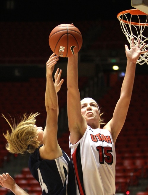 Rick Egan   |  The Salt Lake Tribune

Lady Ute, Michelle Plouffe (15) blocks a shot by Devyn Christensen, USU,  in Basketball action Utah vs. Utah State at the Huntsman Center,  Saturday, January 1, 2011