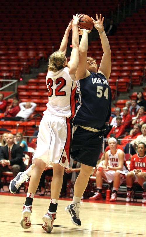 Rick Egan   |  The Salt Lake Tribune

 Lady Utes,Diana Rolniak (32) blocks a shot by Maddy Plunkett (54), Utah State,  in Basketball action Utah vs. Utah State at the Huntsman Center,  Saturday, January 1, 2011