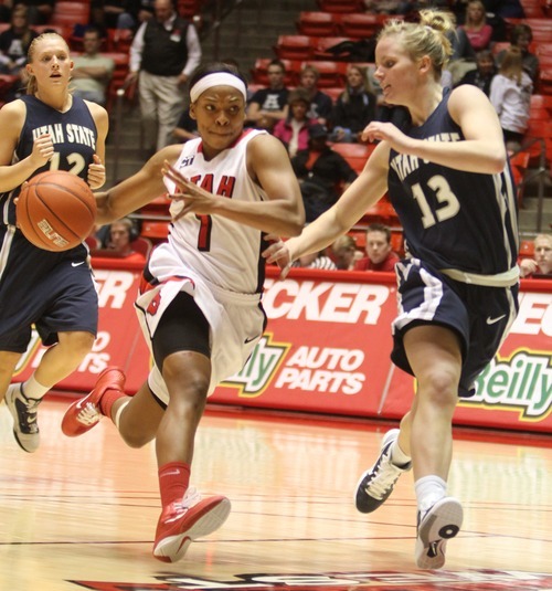 Rick Egan   |  The Salt Lake Tribune

Janita Badon drives leads a fast break, as  Alice Coddington (13) defends for Utah State, in Baskteball action Utah vs. Utah State at the Huntsman Center,  Saturday, January 1, 2011