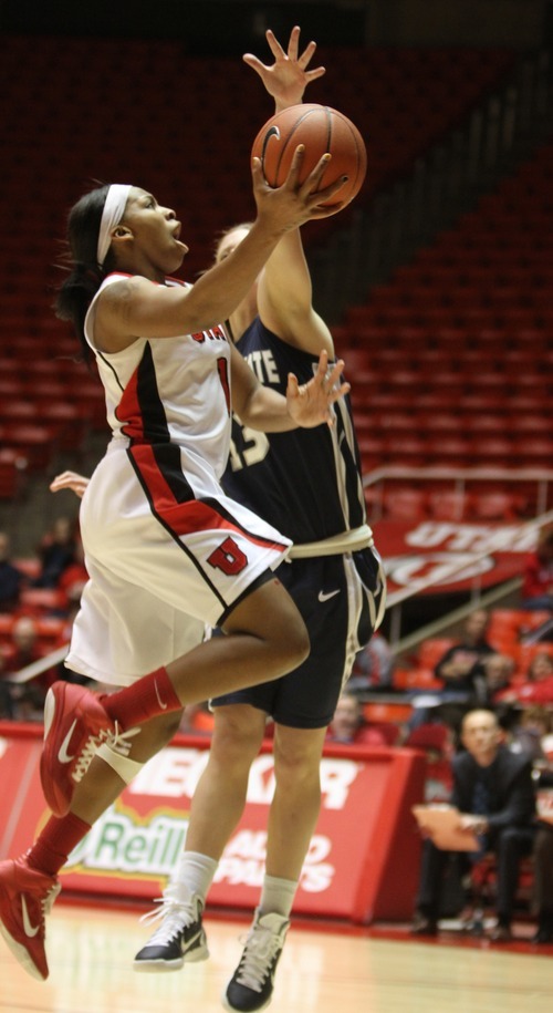 Rick Egan   |  The Salt Lake Tribune

Janita Badon drives leads a fast break, as  Alice Coddington (13) defends for Utah State, in Baskteball action Utah vs. Utah State at the Huntsman Center,  Saturday, January 1, 2011