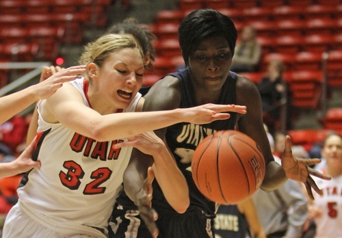 Rick Egan   |  The Salt Lake Tribune

Diana Rolniak battles Utah State's Banna Diop for the ball, in Baskteball action Utah vs. Utah State at the Huntsman Center,  Saturday, January 1, 2011