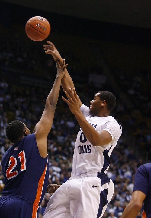 Djamila Grossman  |  The Salt Lake Tribune

Brigham Young University's Brandon Davies, 0, throws the ball as, Fresno Pacific University's Kendall Holmes, 21, blocks him, during the second half of a game in Provo, Saturday, Jan. 1, 2011. BYU won the game.