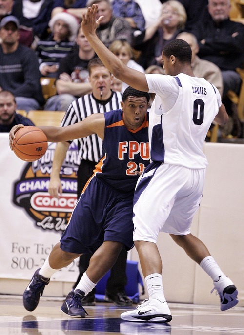 Djamila Grossman  |  The Salt Lake Tribune

Brigham Young University's Brandon Davies, 0, blocks Fresno Pacific University's Kendall Holmes, 21, during the second half of a game in Provo, Saturday, Jan. 1, 2011. BYU won the game.