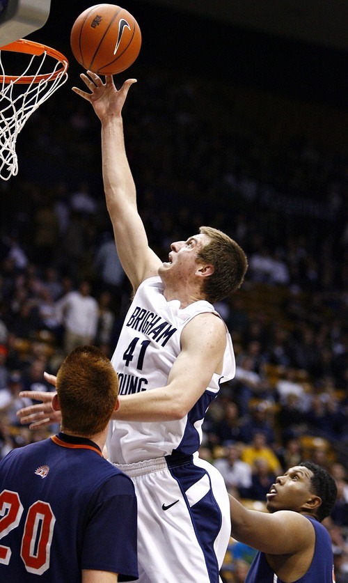 Djamila Grossman  |  The Salt Lake Tribune

Brigham Young University's Chris Collinsworth, 41, drops the ball in the basket as Fresno Pacific University's Jordan Wild, 20, watches, during the second half of a game in Provo, Saturday, Jan. 1, 2011. BYU won the game.