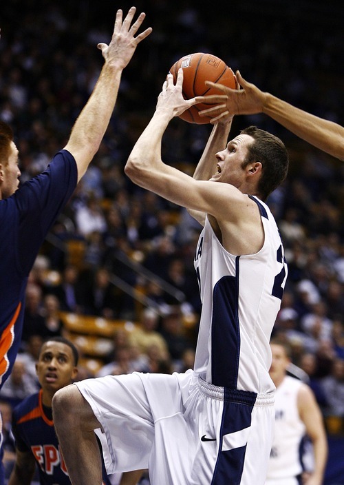 Djamila Grossman  |  The Salt Lake Tribune

Brigham Young University's Stephen Rogers, 21, jumps to score as Fresno Pacific University's Jordan Wild, 20, blocks the ball, during the second half of a game in Provo, Saturday, Jan. 1, 2011. BYU won the game.