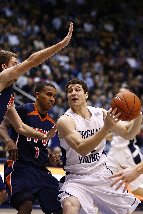 Djamila Grossman  |  The Salt Lake Tribune

Brigham Young University's Jimmer Fredette, 32, gets guarded by Fresno Pacific University's Adam Kado, 1, and Matt Christman, 4, during the second half of a game in Provo, Saturday, Jan. 1, 2011. BYU won the game.