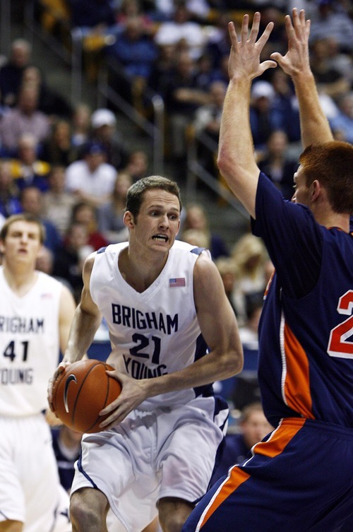 Djamila Grossman  |  The Salt Lake Tribune

Brigham Young University's Stephen Rogers, 21, gets guarded by Fresno Pacific University's Jordan Wild, 20, during the second half of a game in Provo, Saturday, Jan. 1, 2011. BYU won the game.