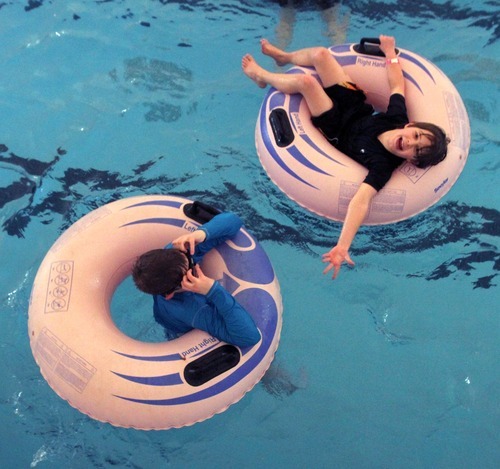 Rick Egan   |  The Salt Lake Tribune

Mathew Kennedy, left, and Christian Bruder, both 10, float in the waves at Layton Surf-N-Swim Dec. 30.