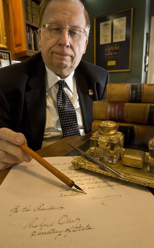 Paul Fraughton  |  The Salt Lake Tribune   
Ron Fox, who has an interest in Utah state history, holds a pen that is similar to the one used by President Grover Cleveland to sign the document that made Utah a state.The pen point is resting on a copy of the last page of the statehood document.  Monday, January 3, 2011.