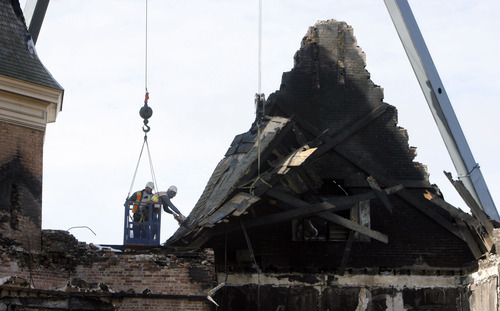 Francisco Kjolseth  |  The Salt Lake Tribune
Crews begin to remove debris Tuesday from the historic Provo Tabernacle following last week's fire that gutted the beloved building.