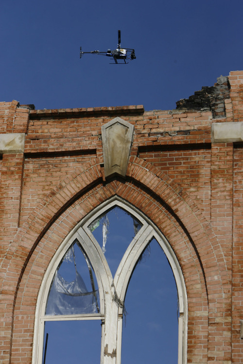 Francisco Kjolseth  |  The Salt Lake Tribune
A highway patrol radio-controlled helicopter, with a camera capable of shooting stills and video, maps out the inside of the burned Provo Tabernacle. Crews have been removing debris following last week's fire that gutted the beloved historic building.