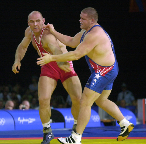 U.S. Olympic wrestler Rulon Gardner, right, slips a move from Russia's Alexandre Kareline during their 130kg gold medal match Sept. 27, 2000. Gardner defeated the Russian 1-0.  Steve Griffin  |  Tribune file photo