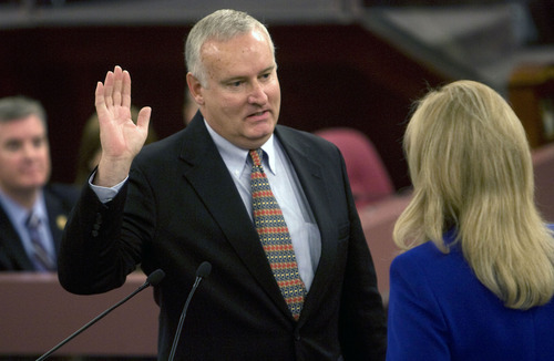 Al Hartmann  |  The Salt Lake Tribune 
New Salt Lake County Council member Richard Snelgrove takes the oath of office from  recorder Sherrie Swenson at a Salt Lake County Inauguration Ceremony Monday morning.  He was among a dozen independent elected officials and Salt Lake County Council members  sworn in for the county on Monday January 3rd.