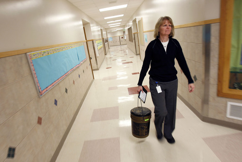 Francisco Kjolseth  |  The Salt Lake Tribune
JoAnn Crawley, principal of Monroe Elementary, carries a fishing bucket containing her teacher evaluation tools as she heads to a classroom to evaluate a teacher. Some Utah school districts evaluate career teachers annually, others every three years, and a few, every five years.