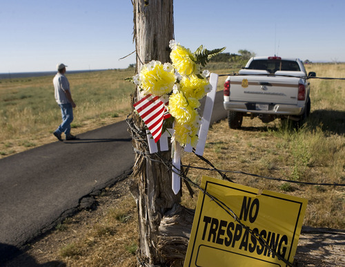 Al Hartmann  |  The Salt Lake Tribune  
BLM agent guards the front gate and private driveway of the Redd home south of Blanding in July 2009 as a team of ten law enforcement and ten archaeologists remove artifacts. It was part of a plea deal with Jeanne Redd and federal prosecutors.
