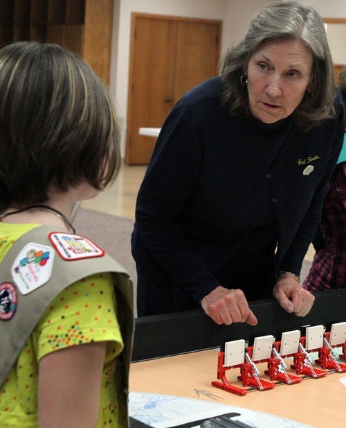 Rick Egan   |  The Salt Lake Tribune

 Ana W. talks to Char Corbit as she watches a robo as they practice for the First Lego League competition, in Salt Lake City,  Monday, December 13, 2010. Corbit is retiring after 33 years leading Girl Scouts Utah.