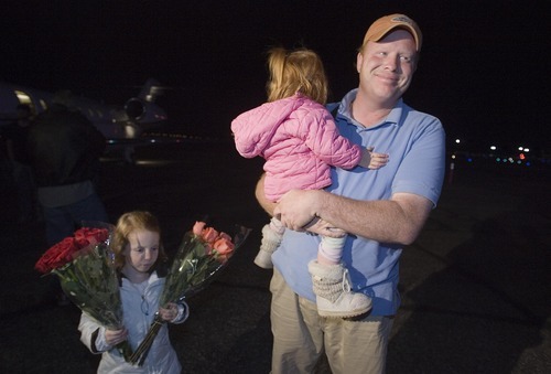 Jim Urquhart  |  The Salt Lake Tribune
Jeremy Johnson, with daughters Allie, left, and Bree, returns to St. George Jan. 26, 2010. Johnson, who spent two weeks in Haiti helping earthquake victims, is accused in a federal lawsuit of taking in $275 million since 2006 in a 