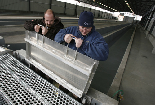 Francisco Kjolseth  |  The Salt Lake Tribune
Wildlife specialist Shane Gurley, left, and Jason Tull, assistant supervisor of the Springville Hatchery, raise a gate in anticipation of the first water flow through the raceways since 2005. The Springville Hatchery is the oldest fish hatchery the state, dating back to the 1890s. It became an official hatchery in 1909. After a $4 million renovation, the hatchery was fired up on Monday, Dec. 27, 2010, with new water systems, covered raceways and other measures to prevent whirling disease and increase production.