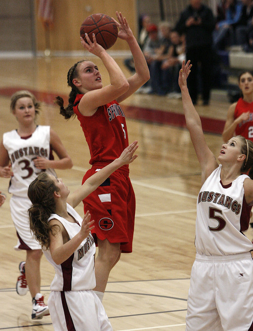 Scott Sommerdorf  l  The Salt Lake Tribune
Springville's Lexi Eaton (5) takes a shot while getting lots of attention from  the Herriman defense during second half play. Springville beat Herriman 60-21, Friday 1/7/2011. #5 for Herriman is Bri Sorenson.