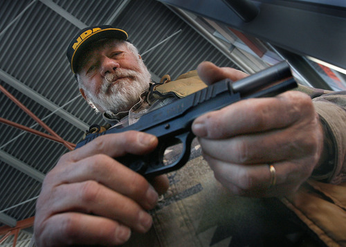 Scott Sommerdorf  l  The Salt Lake Tribune

Ralph Schamel, a lifetime member of the NRA, met people entering the Crossroads of the West Gun Show and offered them free admission in exchange for joining the NRA on Sunday. He also had a handful of guns for sale including this .45 caliber handgun. People attending the show gave their opinions on the impact the shooting in Tucson, Ariz., might have on gun owners.