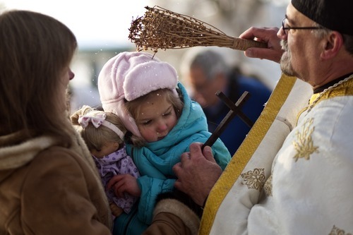 Chris Detrick  |  The Salt Lake Tribune 
Father Elias Koucos, of the Prophet Elias Greek Orthodox Church, blesses Oksana Zapassoff and her daughter Katerina, 4, during a water blessing ceremony at Sugar House Park Thursday January 6, 2011.