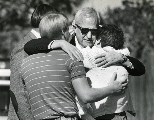 FILE  | The Salt Lake Tribune
J. Gary Sheets, center, is comforted by his daughter, Katie (Sheets) Robertson, in 1985 after arriving at his Salt lake City home, where his wife had been killed in a bomb explosion.