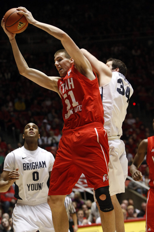 Chris Detrick  |  The Salt Lake Tribune 
Utah Utes center David Foster #51 and Brigham Young Cougars forward Noah Hartsock #34 go for the ball during the game at the Huntsman Center Tuesday January 11, 2011.   BYU won the game 104-79.
