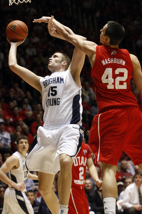 Chris Detrick  |  The Salt Lake Tribune 
Brigham Young Cougars forward/center James Anderson #15 shoots past Utah Utes center Jason Washburn #42 during the game at the Huntsman Center Tuesday January 11, 2011.   BYU won the game 104-79.