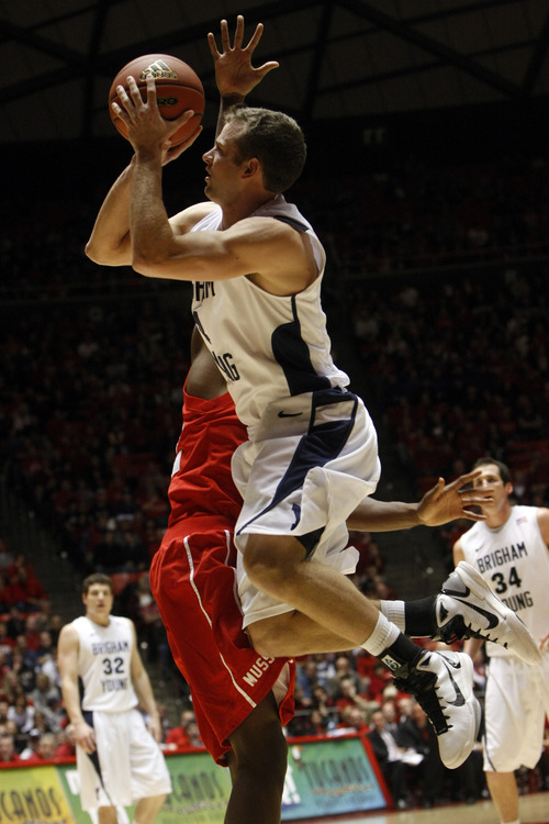 Chris Detrick  |  The Salt Lake Tribune 
Brigham Young Cougars guard Jackson Emery #4 shoots past Utah Utes guard/forward Shawn Glover #32 during the game at the Huntsman Center Tuesday January 11, 2011.   BYU won the game 104-79.