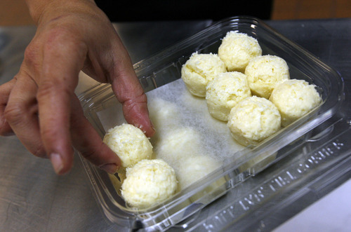 Francisco Kjolseth  |  The Salt Lake Tribune
Debora Hammond arranges 24 balls of dough into a container featuring her family's recipe for gluten-free cheese bread, which  is made with 
