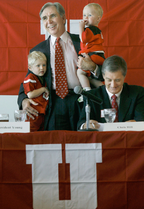 Scott Sommerdorf  |  Salt Lake Tribune
University of Utah President Michael Young holds his grandsons Trevor, left, and Bryce Owen as he talks about the University's acceptance of the Pac-10 invitation. Athletic Director Dr. Chris Hill is at right. The University of Utah officially accepted the offer to join the Pac-10 conference.