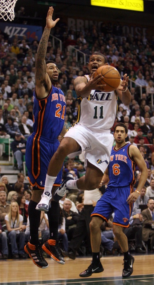 Steve Griffin  |  The Salt Lake Tribune
 
Utah's Earl Watson leaps past New York's Wilson Chandler during the first half of the Jazz versus Knicks basketball game at EnergySolutions Arena in Salt Lake City Wednesday, January 12, 2011.