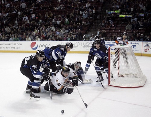 Djamila Grossman  |  The Salt Lake Tribune

The Grizzlies' Marcus Carroll, 8, reaches for the puck as several Idaho Steelheads players try to block it, during a game at the Maverik Center in West Valley City, Wednesday, Jan. 12, 2011. Idaho won the game.