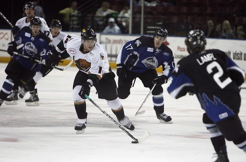 Djamila Grossman  |  The Salt Lake Tribune

The Grizzlies' Tom May, 14, drives the puck across the ice as the Idaho Steelheads' Aki Seitsonen, 17, and Cody Lampl, 2, try to block him, during a game at the Maverik Center in West Valley City, Wednesday, Jan. 12, 2011. Idaho won the game.