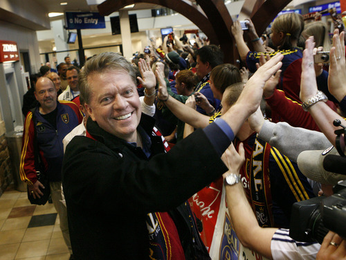 Scott Sommerdorf  |  Salt Lake Tribune
RSL owner Dave Checketts slaps hands Monday of RSL fans as he walks down the line of some of the hundreds of fans who showed up at the airport to greet the team. The Real Salt Lake team brings the MLS cup home to the Salt Lake International Airport.
