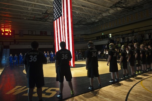 Chris Detrick  |  The Salt Lake Tribune 
While wearing 'Super Dale' shirts, members of the Wasatch wrestling team stand during the National Anthem during the wrestling match at Wasatch High School Thursday January 13, 2011.  Wrestler Dale Lawrence was injured during a wrestling practice January 4.