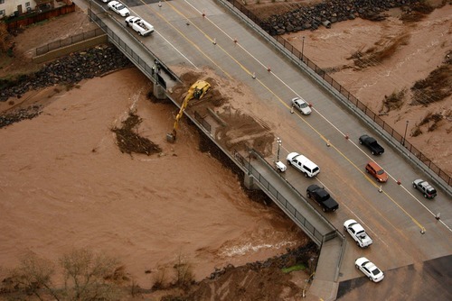 Trent Nelson  |  The Salt Lake Tribune
Workers clear debris (mainly trees) from underneath the bridge at Valley View Drive on the Santa Clara River Dec. 22. Installing rock lining on multiple locations along the river is among projects proposed for federal funding.