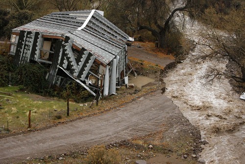 Trent Nelson  |  The Salt Lake Tribune
High waters in Beaver Dam Wash in December washed out a road in Motoqua, Utah, next to a structure damaged in the 2005 flooding.