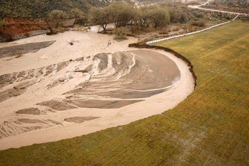 Trent Nelson  |  The Salt Lake Tribune
The raging Santa Clara River gobbles a huge chunk of a field near Gunlock Dec. 22.