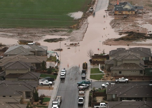 Rick Egan   |  The Salt Lake Tribune

Floodwaters cover a road in Washington, near St. George, Dec. 21, 2010.