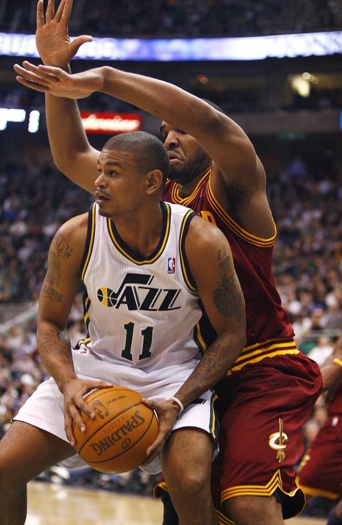 Djamila Grossman  |  The Salt Lake Tribune

The Utah Jazz's Earl Watson, 11, is guarded by Cleveland's Ramon Sessions, 3, during a game in Salt Lake City, Friday, Jan. 14, 2011. The Jazz won the game.