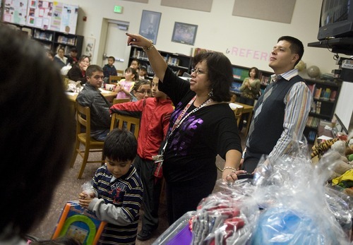 Djamila Grossman  |  The Salt Lake Tribune
Maria Barajas hands out presents, part of a raffle, at a nutrition fair she organized at Rose Park Elementary School, Saturday, Nov. 13, 2010. The fair was intended to educate community members about eating right, diabetes, and eating disorders, among other issues.