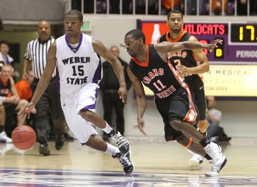 Rick Egan   |  The Salt Lake Tribune

Lindsey Hughey (15) Weber, is chased by Bengal, Kenny McGowen as time runs down, in basketball action Weber State vs Idaho State, in Ogden, Saturday, January 15, 2011