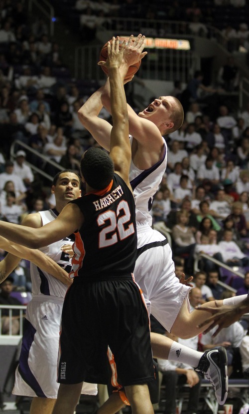 Rick Egan   |  The Salt Lake Tribune

Kyle Bullinger (3)  goes to the basket for the WIldcats,, as Andre Hatchett (22) defends, in basketball action Weber State vs Idaho State, in Ogden, Saturday, January 15, 2011