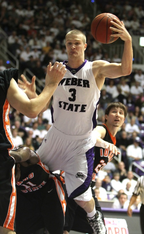 Rick Egan   |  The Salt Lake Tribune

Kyle Bullinger, gets called for a foul as he collides with Kenny McGowen (11) ISU,  in basketball action Weber State vs Idaho State, in Ogden, Saturday, January 15, 2011