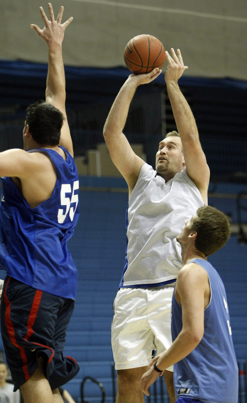 Chris Detrick  |  The Salt Lake Tribune 
Chad Kartchner #35 shoots past Tika Wesley #55 during the alumni game at Salt Lake Community College Saturday January 15, 2011.  The Old Men team  defeated the Young Men team 71-65 in overtime.